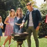Family barbequing on a sunny day.