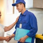 Female resident shaking hands with a plumber